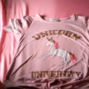 A pink shirt,brand is dream girl the size is a kids small